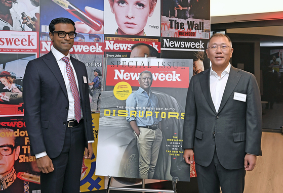 Hyundai Motor Group Chairman Euisun Chung, right, poses with Newsweek CEO Dev Pragad in front of a poster of Newsweek's special edition. [HYUNDAI MOTOR GROUP]