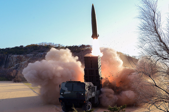 North Korea launches a tactical guided weapon from a transporter erector launcher (TEL) under the supervision of North Korean leader Kim Jong-un, in a photo released by the North's official Korean Central News Agency (KCNA) Sunday. South Korea's military said the North launched two projectiles from its east coast into the East Sea at 6 p.m. Saturday. [KCNA]
