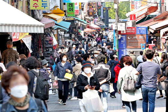 Shoppers enjoy Namdaemun Market in central Seoul on Monday after 757 days of Covid-19 social distancing restriction ended. [JANG JIN-YOUNG]
