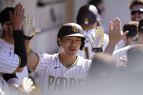 San Diego Padres' Kim Ha-seong is greeted by teammates after hitting a home run during the seventh inning of a game against the Cincinnati Reds at Petco Park in San Diego on Wednesday. [AP/YONHAP]