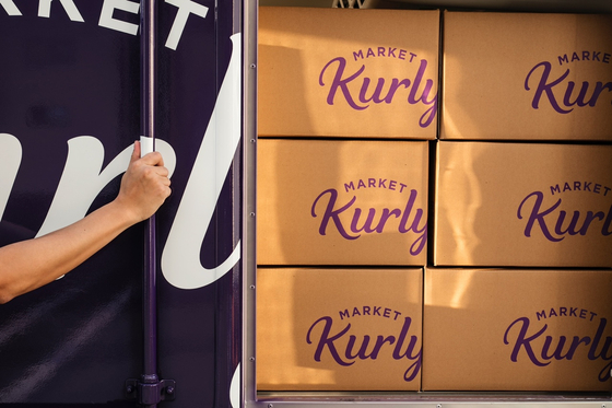 Market Kurly's deliveries are stacked in a delivery truck. [KURLY] 