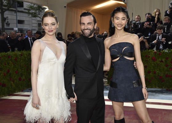 Emma Stone, from left, Nicolas Ghesquiere and HoYeon Jung attend The Metropolitan Museum of Art's Costume Institute benefit gala celebrating the opening of the ″In America: An Anthology of Fashion″ exhibition on Monday, May 2, 2022, in New York. (Photo by Evan Agostini/Invision/AP)