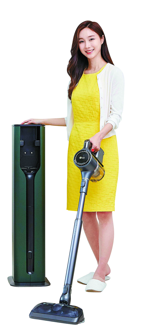 A model stands beside LG Electronics' All-in-One Tower for its cordless vacuum cleaners. [LG ELECTRONICS]