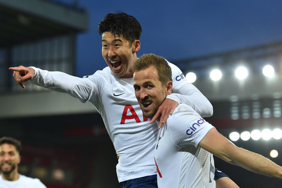 Tottenham Hotspur striker Son Heung-min celebrates with Harry Kane after scoring the opening goal of the Premier League match between Liverpool and Tottenham Hotspur at Anfield in Liverpool, northwest England, on Saturday. [AFP/YONHAP]