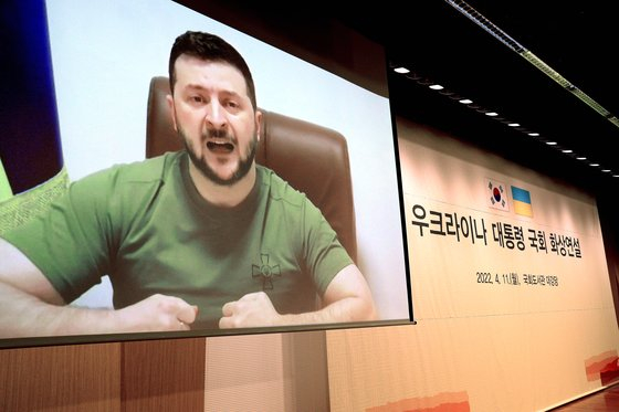 Ukrainian President Volodymyr Zelensky delivers a speech via video in the auditorium of the National Assembly Library on April 11, with lawmakers in attendance. In his speech, he asked South Korea to send Ukraine offensive weapons. [KIM SANG-SEON]