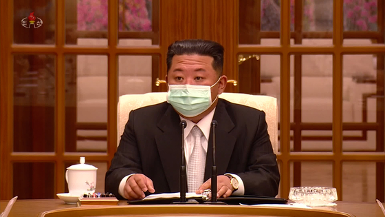 In this footage released by the state-run Korean Central Television, North Korean leader Kim Jong-un appears wearing a mask in public for the first time at a Thursday meeting of the ruling Workers' Party Politburo in Pyongyang. [YONHAP]