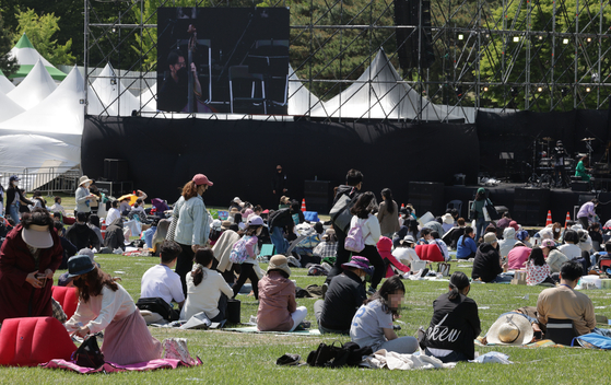 An audience enjoys the outdoors in ″Wonderland Festival 2022″ on May 1 at the 88 Grass Garden in Songpa District, southern Seoul. [YONHAP]