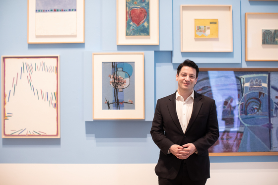Mark Tetto poses in front of numerous Kim Whanki (1913-1974) paintings at the Whanki Museum in central Seoul last week. [WHANKI MUSEUM]