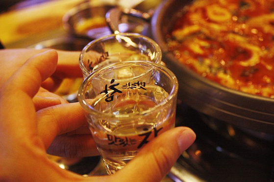 People drink soju, pairing it with a spicy stew. [PIXABAY]