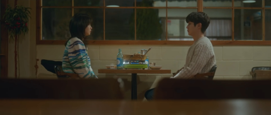 Yeon-soo and Ung drink HiteJinro's Jinro soju in a scene from ″Our Beloved Summer" (2021). [SCREEN CAPTURE]