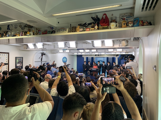 Reporters try to capture BTS on their cameras and phones as the boy band visits the James S. Brady Briefing Room of the White House on May 31. [JOINT PRESS CORP]