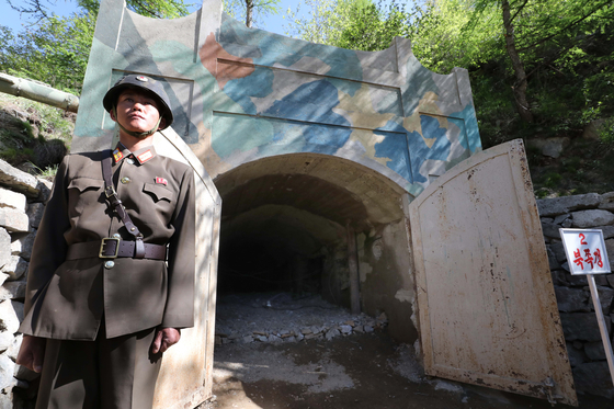 A North Korean soldier stands guard outside the No. 2 tunnel at the Punggye-ri underground nuclear testing site in North Pyongan Province in May 2018. [JOINT PRESS CORPS]