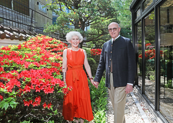 Wolfgang Angerholzer, ambassador of Austria to Korea, right, and his wife Susanne Angerholzer, left, at their garden fully bloomed with azaleas at the diplomatic residence in Seoul on April 26. [PARK SANG-MOON]