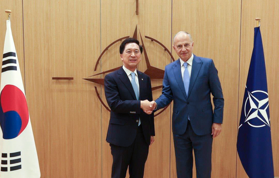People Power Party Rep. Kim Gi-hyeon, left, President Yoon Suk-yeol's special envoy to the European Union, shakes hands with Mircea Geoana, deputy secretary general of the North Atlantic Treaty Organization, at the NATO's headquarters in Brussels, Belgium, last Wednesday. [FOREIGN MINISTRY]