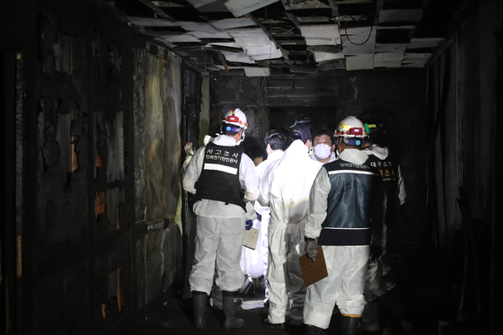 Police officers and members of the National Forensic Service arrive at the site of a suspected case of arson in Suseong District, southeastern Daegu on Friday. [YONHAP]