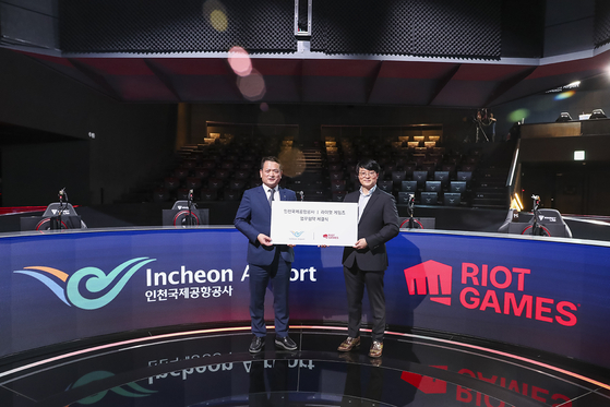 Kim Kyung-wook, President of the Incheon International Airport Corporation, left, poses with Riot Games Korea CEO Jo Hyuk-jin after signing an agreement Monday at the LoL Park in central Seoul. [RIOT GAMES KOREA]