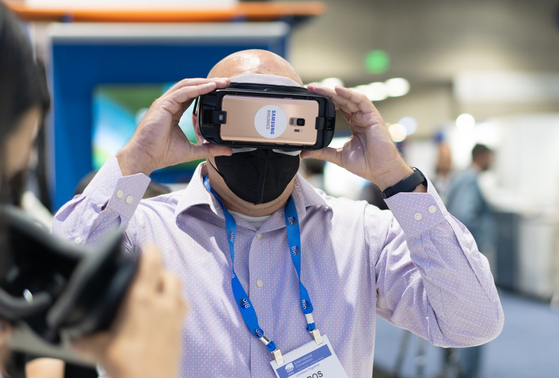 A visitor participates in a virtual reality program to look at Samsung Biologics’ third manufacturing plant in the company’s booth at the BIO USA 2022 Tuesday. [SAMSUNG BIOLOGICS]