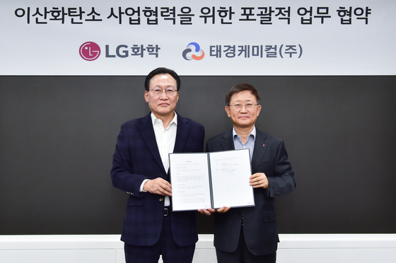Noh Kug-lae, left, head of petrochemical business at LG Chem, poses for a photo with Park Ki-hwan, CEO of Taekyung Chemical, after signing an agreement on the cooperation on the use of carbon dioxide produced in the soon-to-be-built hydrogen plant. [LG CHEM]