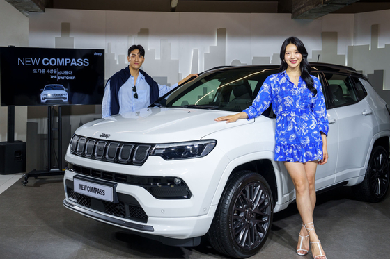 Models pose with Jeep's new Compass SUV during a launch event in eastern Seoul on Thursday. [STELLANTIS KOREA]