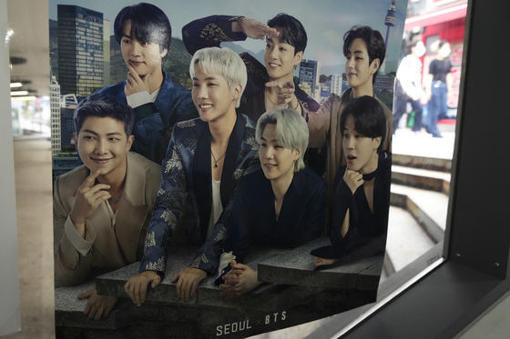 A poster showing BTS members is displayed at a tourist information center in Seoul on June 15. [AP/YONHAP]