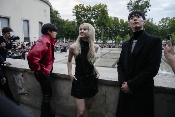 From left to right, V of BTS, Lisa of Blackpink and Park Bo-gum pose for photographers ahead of Celine's Spring Summer 2023 men's collection presented in Paris on June 26. [AP/YONHAP]