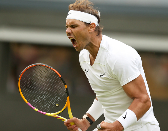 Rafael Nadal of Spain celebrates scoring against Francisco Cerundolo of Argentina during the men's singles first round match at Wimbledon on Centre Court at the All England Lawn Tennis and Croquet Club in London on Tuesday. [XINHUA/YONHAP]