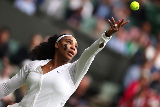 Serena Willams of the United States serves during her first round match against France's Harmony Tan at the All England Lawn Tennis and Croquet Club in London on Tuesday. [REUTERS/YONHAP]
