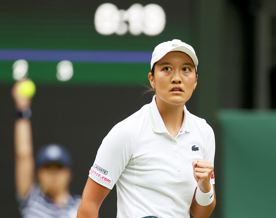 Harmony Tan celebrates after scoring against Serena Williams during the women's singles first round match at the All England Lawn Tennis and Croquet Club in London on Tuesday. [REUTERS/YONHAP]
