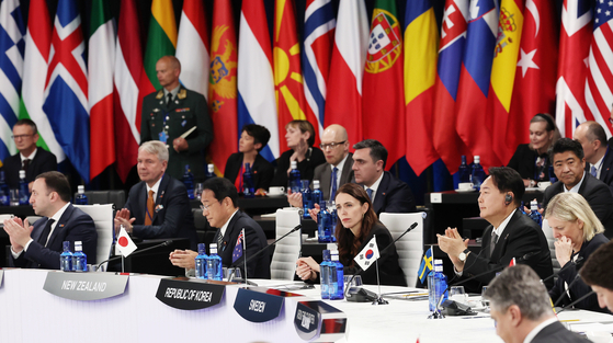 President Yoon Suk-yeol, right, takes part in a session of the NATO Summit at the IFEMA Convention Center in Madrid Wednesday afternoon. [YONHAP] 