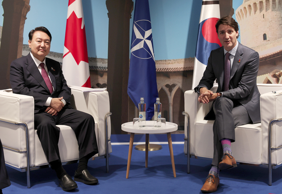 President Yoon Suk-yeol, left, with Canadian Prime Minister Justin Trudeau during their meeting in Madrid on Thursday. [YONHAP] 