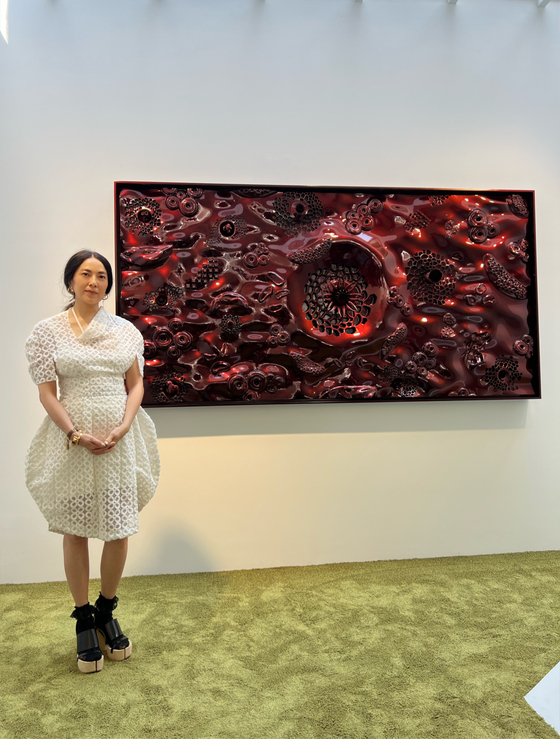 Artist Anicka Yi stands with her work ″Soft Power Narcissist″ (2022) at Gladstone Seoul in Gangnam district, southern Seoul. [GLADSTONE]