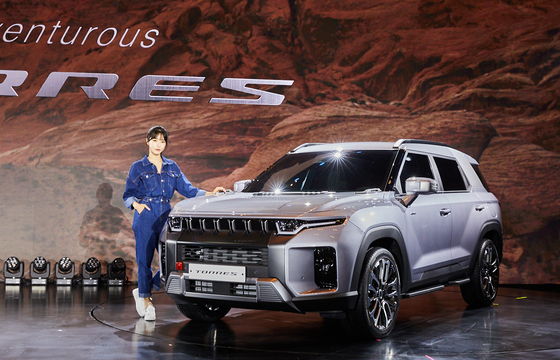 A model poses with the Torres SUV after a release event held at Nest Hotel in Incheon on Tuesday. [SSANGYONG MOTOR]
