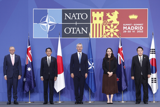 NATO Secretary-General, Jens Stoltenberg, center, poses for photographers next to Australia's Prime Minister Anthony Albanese, far left, Japan's Prime Minister Fumio Kishida, second from left, New Zealand's Prime Minister Jacinda Ardern, second from right, and South Korea's President Yoon Suk-yeol, far right, on the first day of the NATO Summit at IFEMA Convention Center, in Madrid, Spain, on June 29. [EPA/YONHAP]