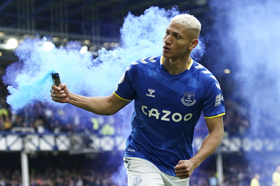 Richarlison, who at the time played for Everton, runs with a flare as he celebrates after scoring a goal during a Premier League game against Chelsea at Goodison Park in Liverpool on May 1. [AP/YONHAP]