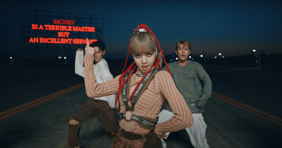 Lisa of girl group Blackpink wears box braids, a popular African hairstyle, in a performance video for her 2021 hit "Money." [YG ENTERTAINMENT]