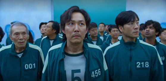 A scene from Netflix's "Squid Game" (2021). From left, actors Oh Young-soo, Lee Jung-jae and Park Hae-soo play characters who compete among 456 contestants to become the sole survivor who wins a grand prize money. [NETFLIX]