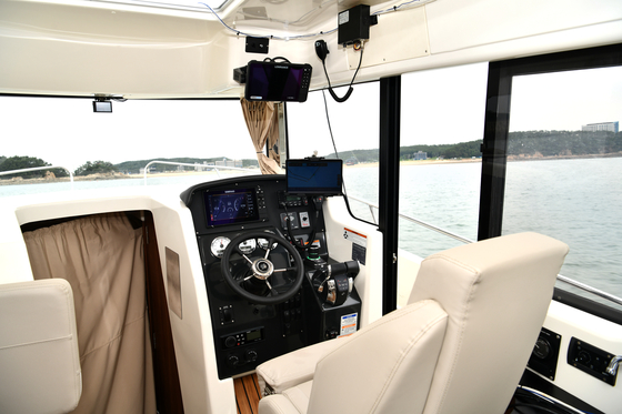 The captain's seat is left empty on a leisure boat equipped with autonomous navigation technology. [AVIKUS]