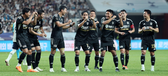 Team K League celebrates after Jun Amano, center, scored the squad's third goal in an exhibition game against Tottenham Hotspur at Seoul World Cup Stadium in Mapo District, western Seoul on Wednesday. [NEWS1]