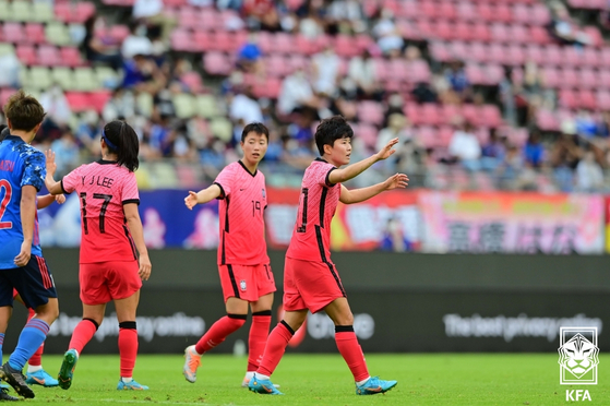 Ji So-yun, right, celebrates after scoring Korea's sole goal during a 2022 EAFF E-1 Football Championship match against Japan at Kashima Soccer Stadium in Kashima, Japan on Tuesday. [KFA/YONHAP]