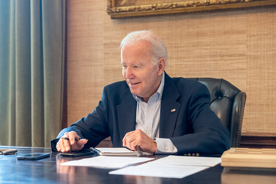 U.S. President Joe Biden sits at his desk in the White House residence in this handout photo obtained from President Biden's Twitter account on July 21. [REUTERS, YONHAP]