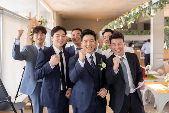 Yang Seung-won, second from front right, with his friends who helped MC the wedding and bless the ceremony with special performances, on the wedding day. [LEE KUN-YOUNG]