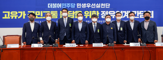 Park Hong-keun, fourth from the left, floor leader of the Democratic Party (DP), poses for a photo with representatives from the oil refiners — S-Oil, GS Caltex, SK energy, and Hyundai Oilbank — and DP lawmakers during a meeting on profit-sharing held Monday at National Assembly. [NEWS1]