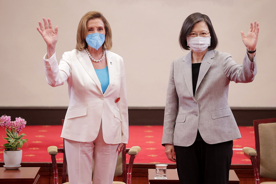 This handout taken and released by Taiwan's Presidential Office on Wednesday shows U.S. House Speaker Nancy Pelosi, left, waving beside Taiwan's President Tsai Ing-wen at the Presidential Office in Taipei. [AP/YONHAP]