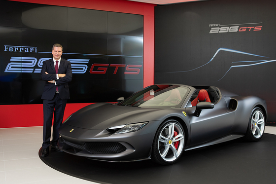 Dieter Knechtel, president at Ferrari Far East and Middle East Hub, poses with the 296 GTS sports car. [FERRARI]