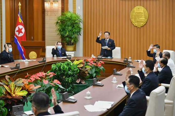 Choe Ryong-hae, center, a member of the Presidium of the Political Bureau of the Central Committee of North Korea's Workers' Party, presides over a plenary session of the standing committee of the Supreme People's Assembly at the Mansudae Assembly Hall in Pyongyang on Sunday, in a photo released by the official Korean Central News Agency Monday. 