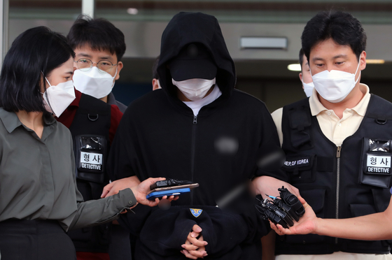 A male student of Inha University who allegedly raped and caused a fellow student to fall to her death leaves Incheon Michuhol Police Precinct on July 22. [NEWS1]