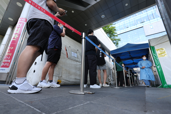 People line up at a Covid-19 testing site in Yongsan District, central Seoul on Thursday. [YONHAP]