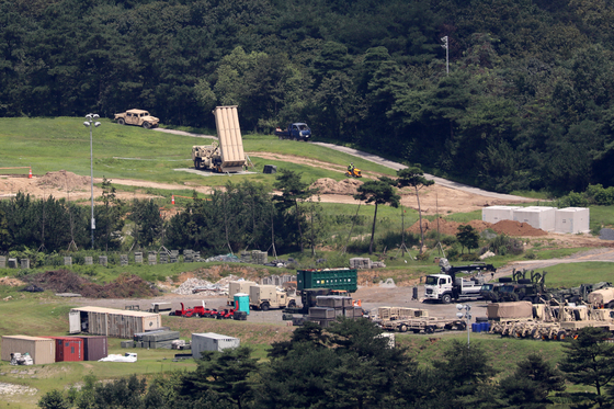 Construction trucks move around launching pads for the Terminal High Altitude Area Defense (Thaad) anti-missile battery in Seongju County, North Gyeongsang, on Thursday. Korea’s presidential office told reporters on Aug. 11 that the operation of the Thaad base would be normalized by the end of this month. [NEWS1]