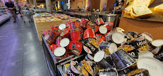 Nongshim's Shin Ramyun and Tempura Udon cup noodles are sold at a discount mart in Interlaken, Switzerland, on June 16. [JOONGANG ILBO]