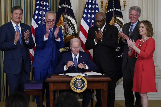 President Joe Biden signs the Democrats' landmark climate change and health care bill in the State Dining Room of the White House in Washington, Tuesday, Aug. 16, 2022. [AP]